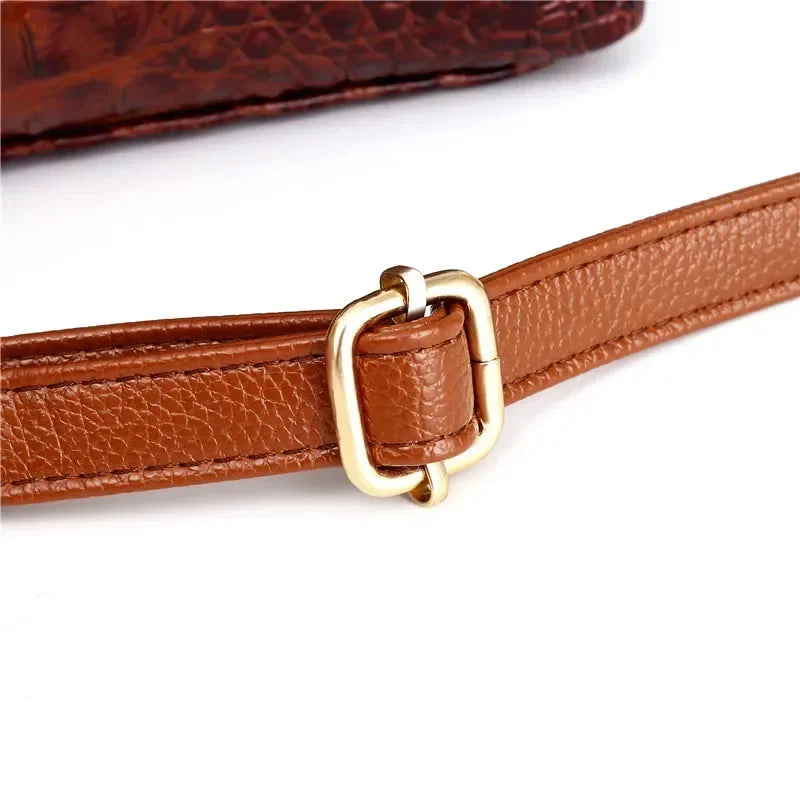 Croc-embossed leather satchel with top handles and crossbody strap