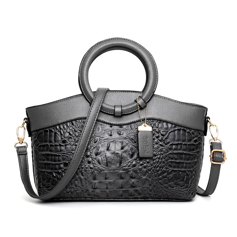 Croc-embossed leather satchel with top handles and crossbody strap