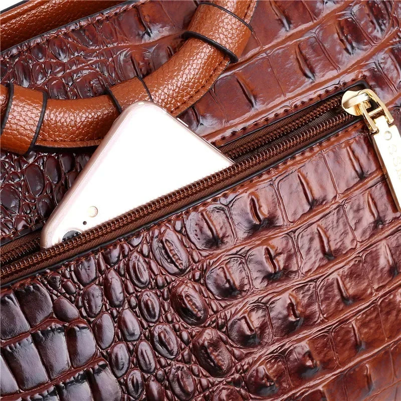 Croc-embossed leather satchel with top handles and crossbody strap