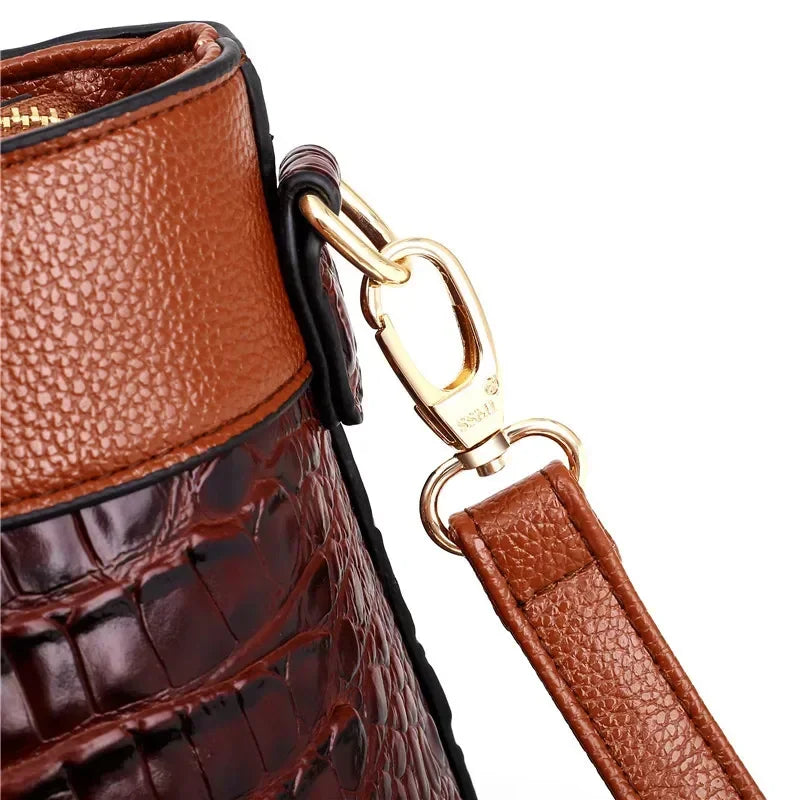 Croc-embossed leather satchel with top handles and crossbody strap