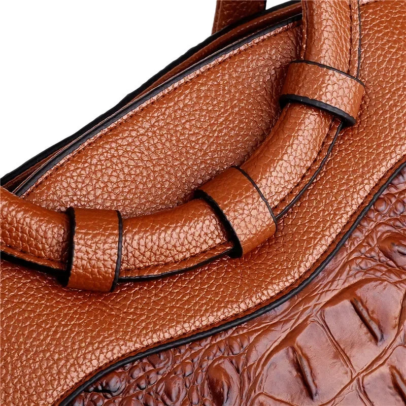 Croc-embossed leather satchel with top handles and crossbody strap